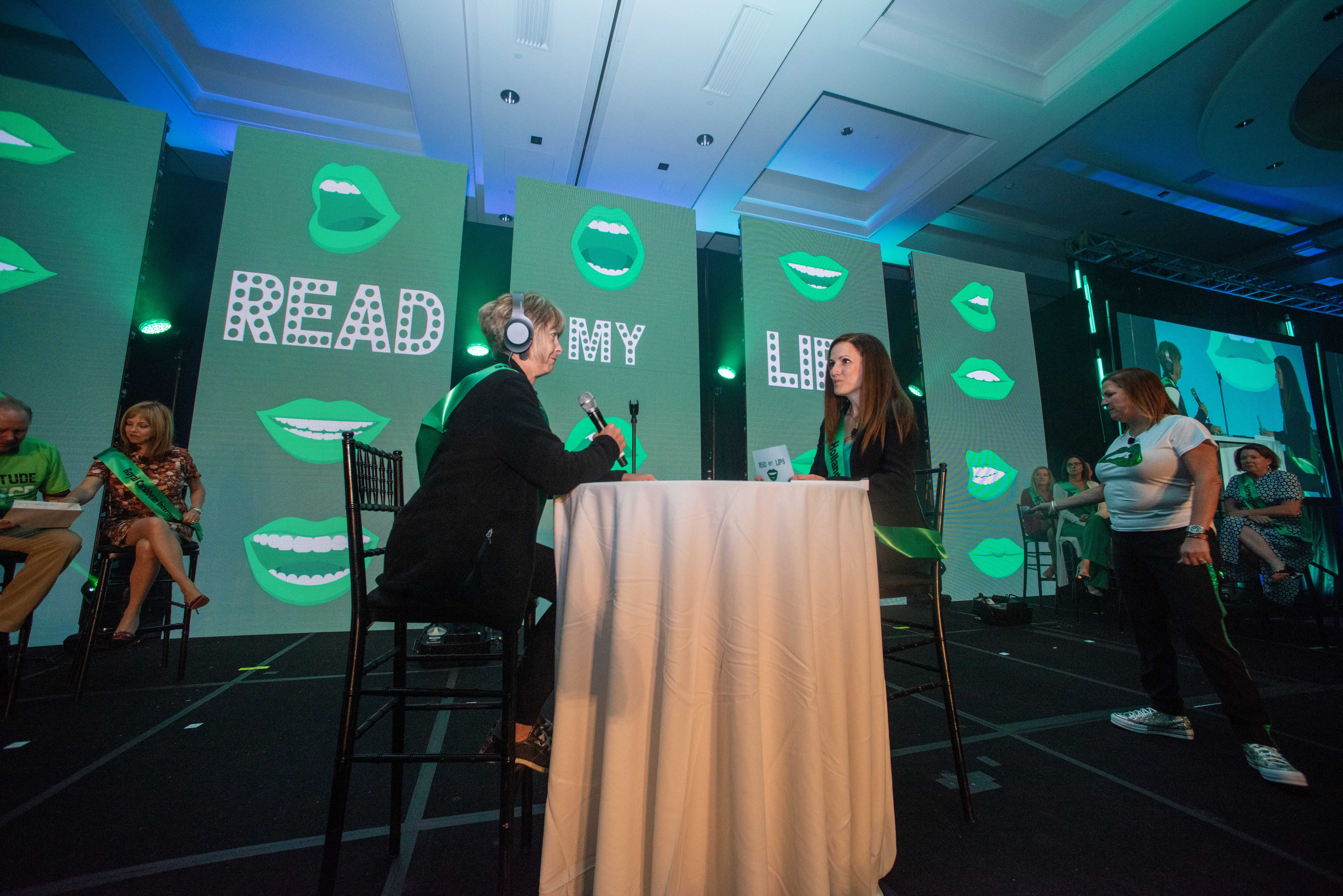 Lisa Griffith, Cruise Planners franchise owner, playing Read My Lips with Michelle Sutter, Director of Sales, Strategic Accounts, Holland America Line